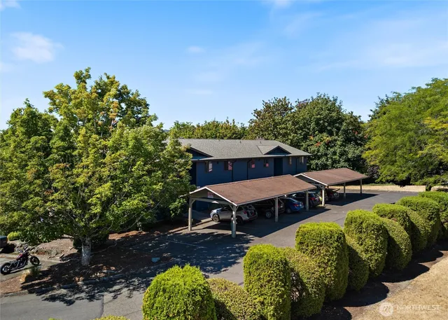 a view of backyard with outdoor seating and green space