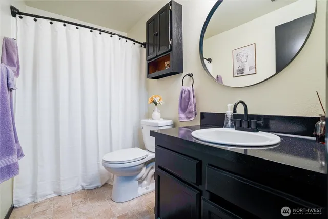 a bedroom with a bed and a large mirror