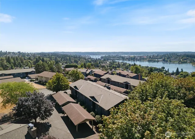 an aerial view of a house with a yard and lake view