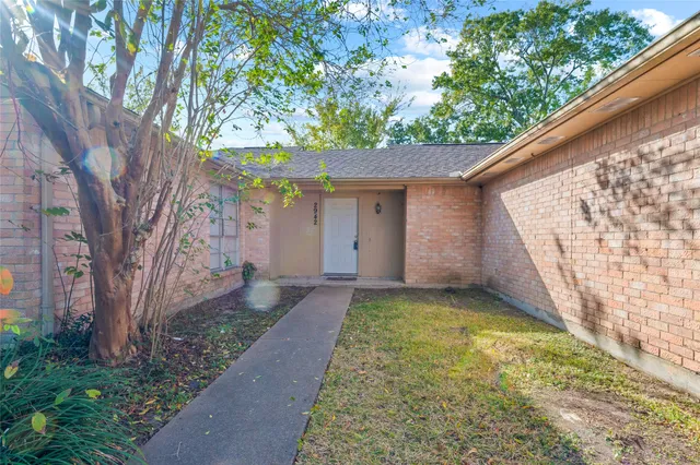 a view of a yard with a large tree