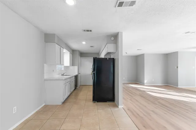 a kitchen with a refrigerator and a sink