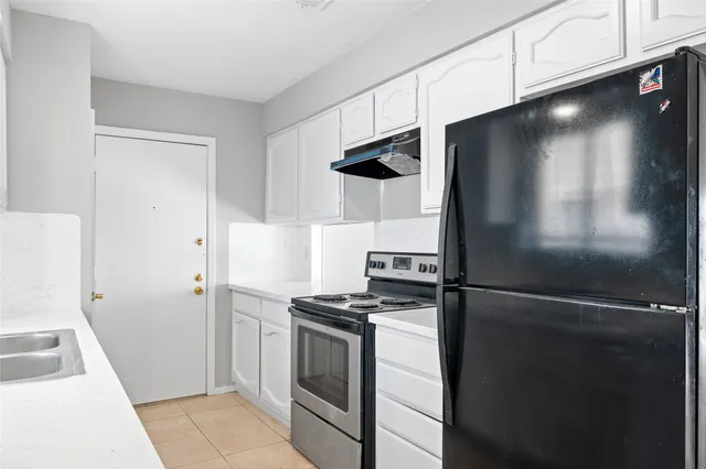 a kitchen with a refrigerator and a stove