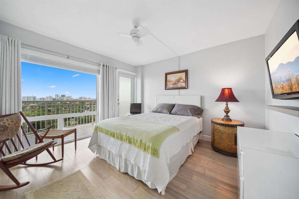 2611 North Riverside Drive, Unit 1106 Pompano Beach, FL 33062 - Photo 4 of 28 a bedroom with a bed and a flat screen tv