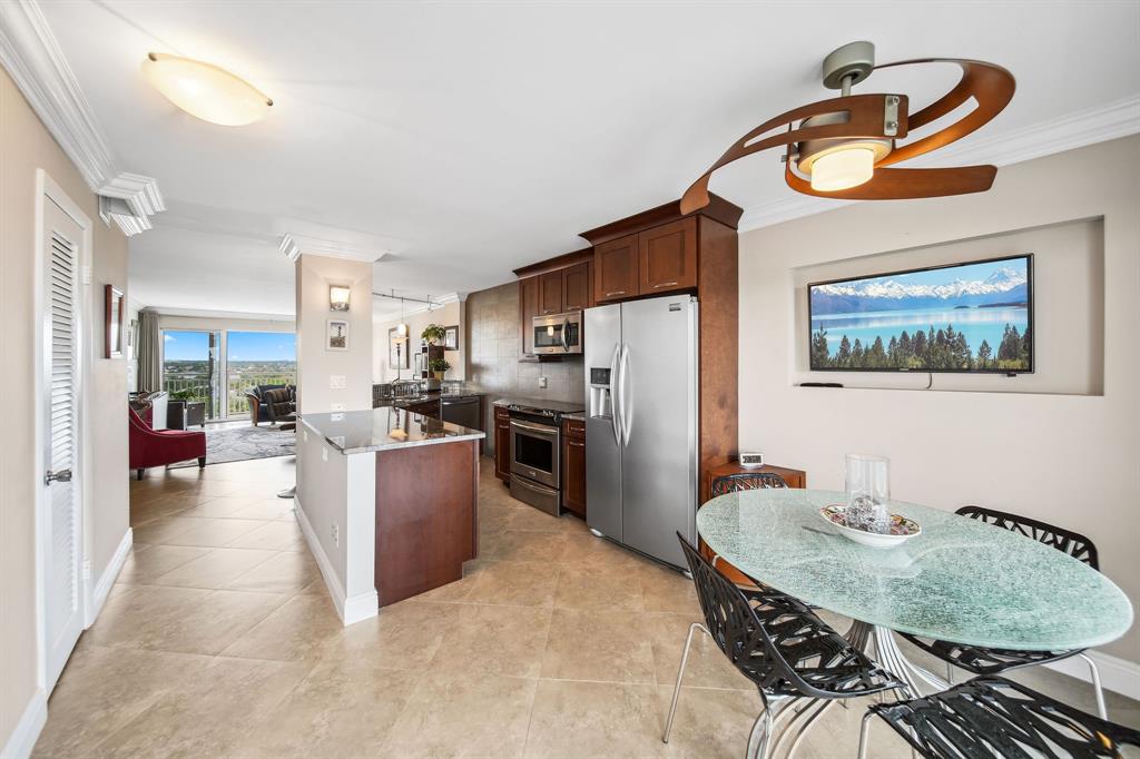 2611 North Riverside Drive, Unit 1106 Pompano Beach, FL 33062 - Photo 7 of 28 a living room with furniture a refrigerator and a table