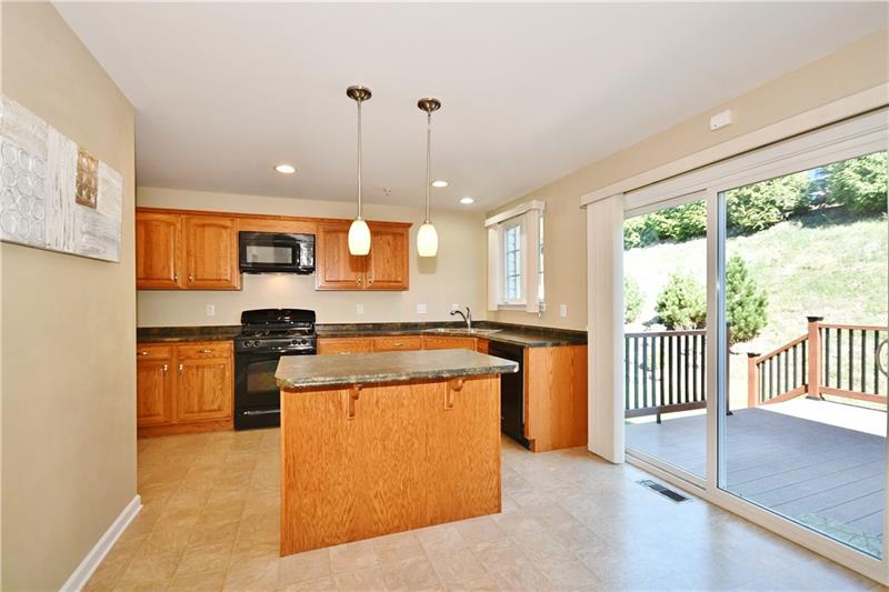 335 Maple Ridge Drive Canonsburg, PA 15317 - Photo 9 of 25 The kitchen island near the sliding glass doors is the perfect place to sit for a snack, meal or to catch up on a little work.