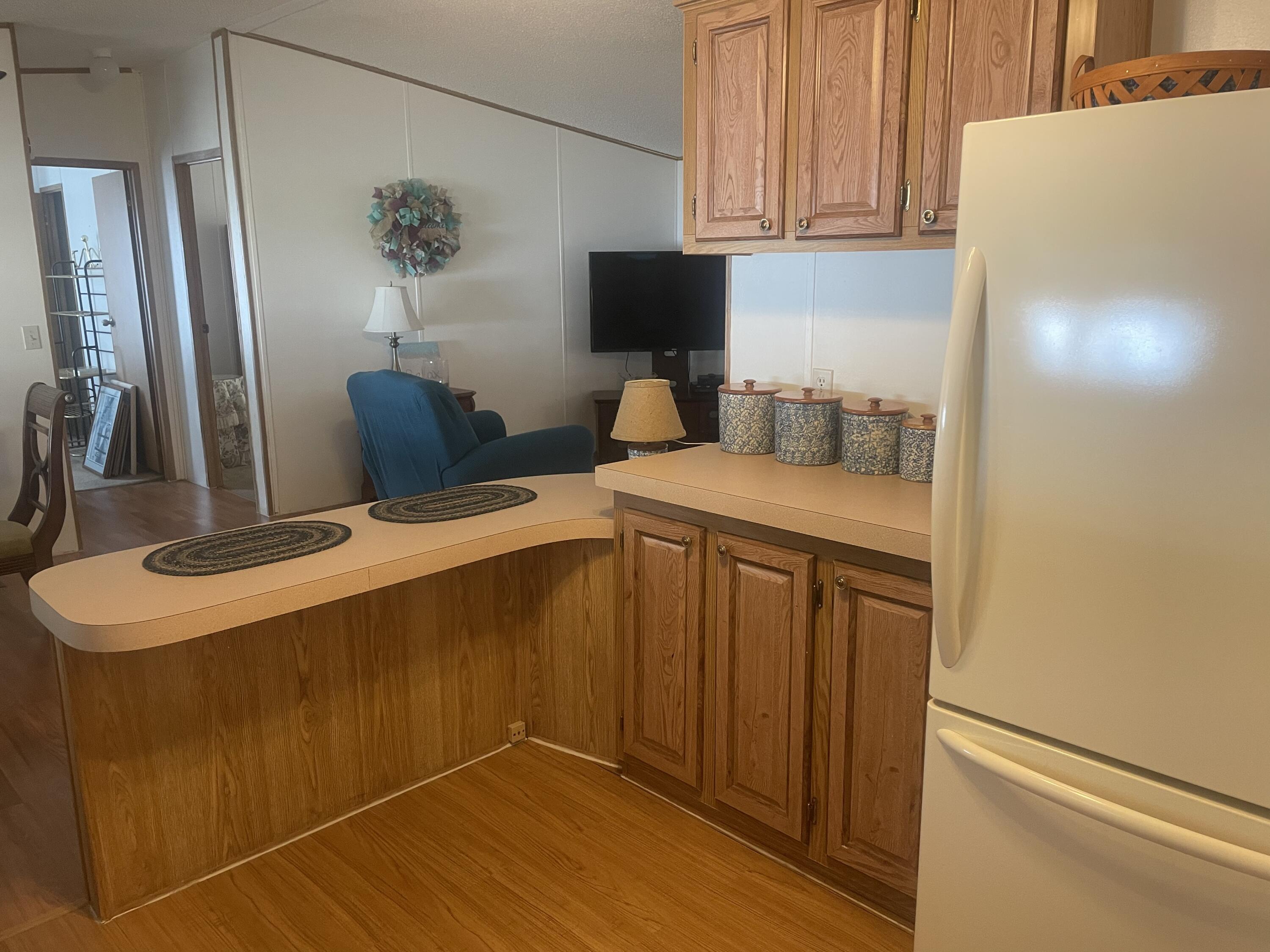 4281 Southwest 15th Way Okeechobee, FL 34974 - Photo 6 of 12 a kitchen with stainless steel appliances a microwave a sink and a refrigerator