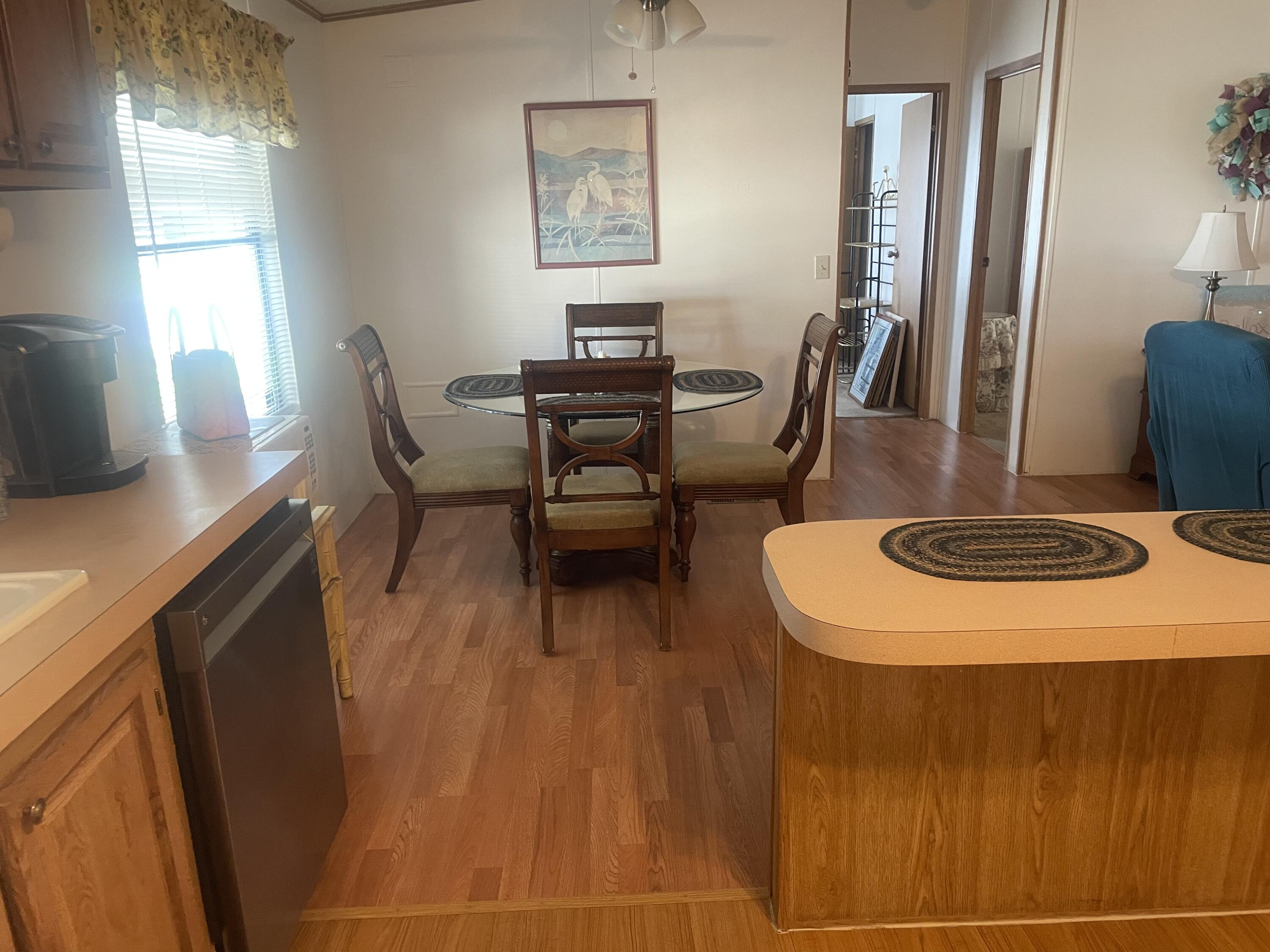 4281 Southwest 15th Way Okeechobee, FL 34974 - Photo 7 of 12 a view of a dining room with furniture and a chandelier