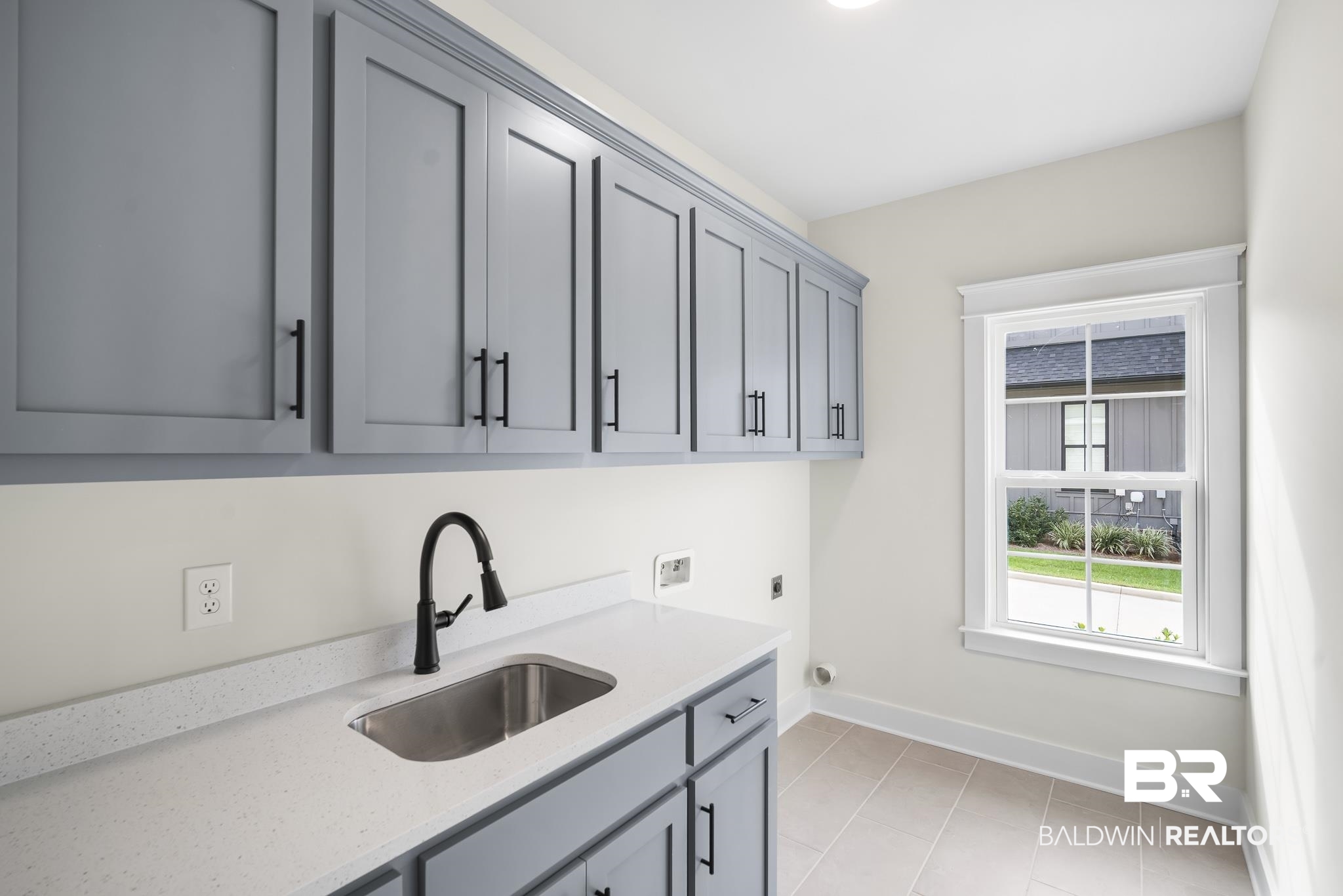 21826 Veranda Boulevard Fairhope, AL 36532 - Photo 29 of 42 Laundry room featuring light tile patterned flooring, electric dryer hookup, hookup for a washing machine, and cabinet space