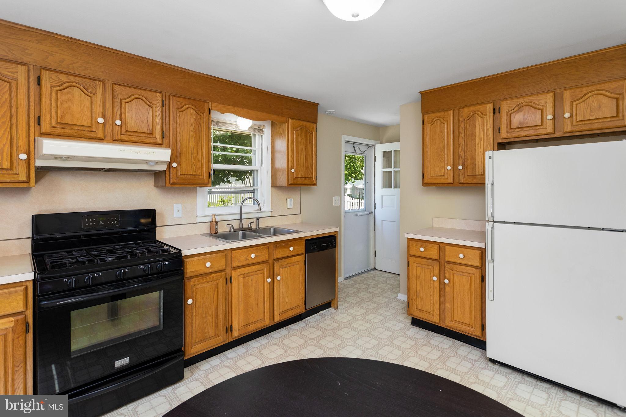 5 Roslyn Road Hamilton, NJ 08610 - Photo 8 of 27 a kitchen with stainless steel appliances granite countertop a stove sink and refrigerator