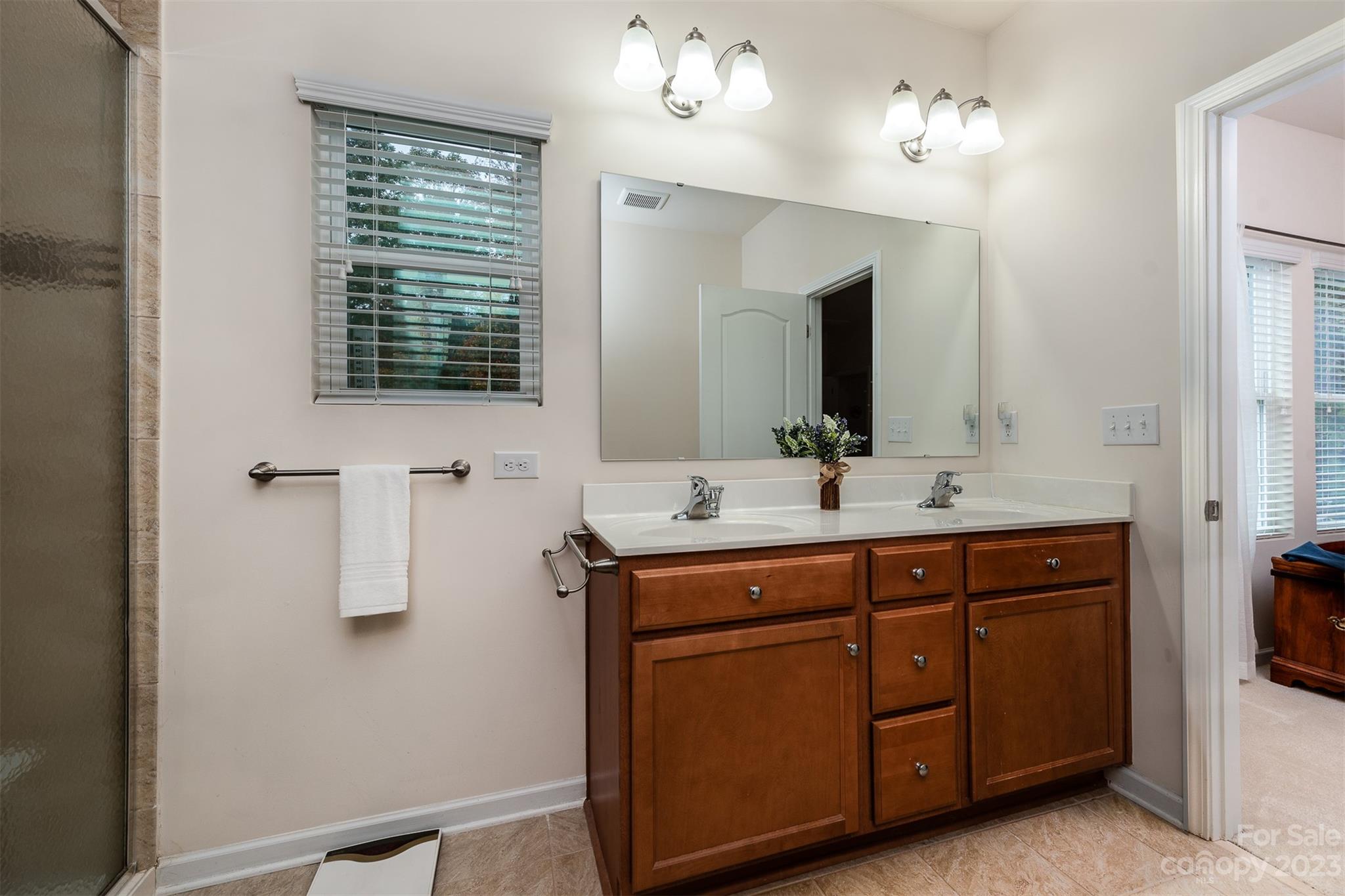 1723 Still River Way Fort Mill, SC 29708 - Photo 16 of 38 a spacious bathroom with a double vanity sink a mirror and a shower