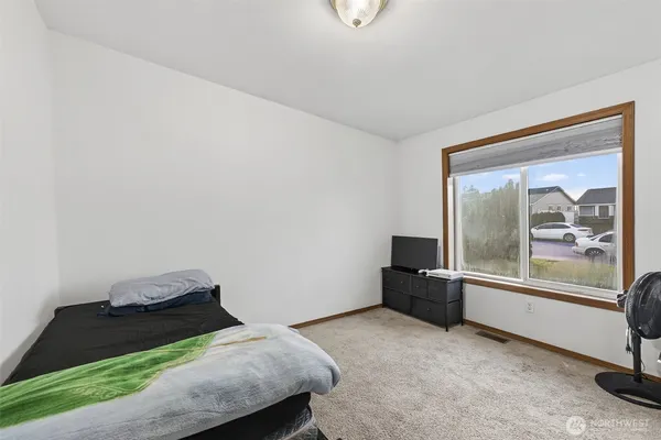 a room with a bed and a large window