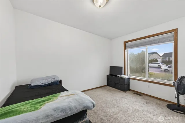 a room with a bed and a large window