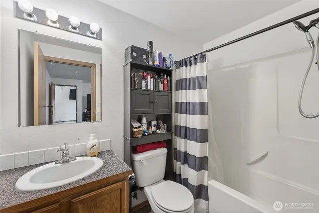 a bathroom with a sink toilet and shower