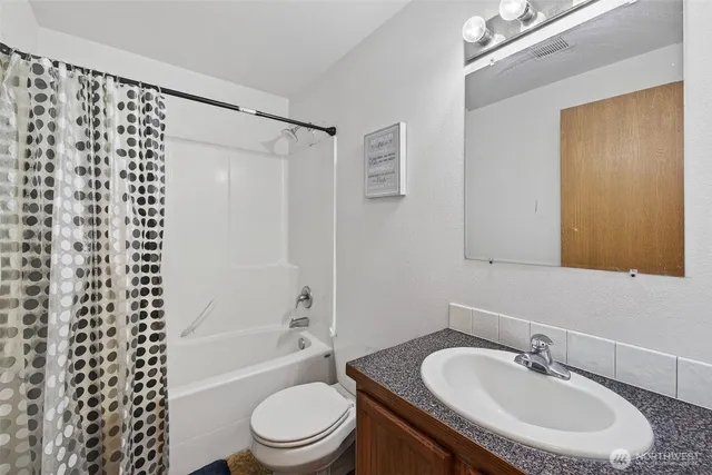 a bathroom with a sink a toilet and a bathtub