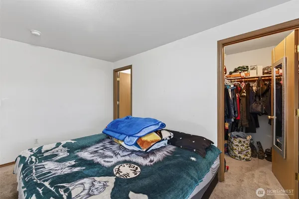 a bed sitting in a bedroom next to a window