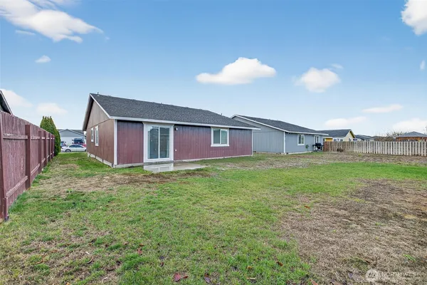 a view of a house with a backyard