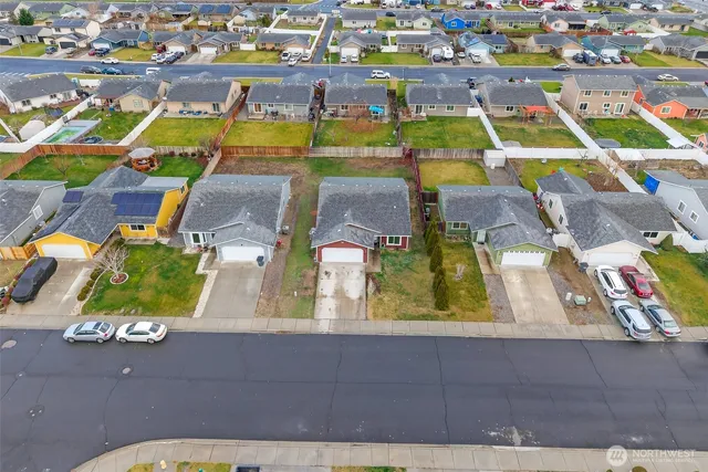 an aerial view of residential houses with outdoor space