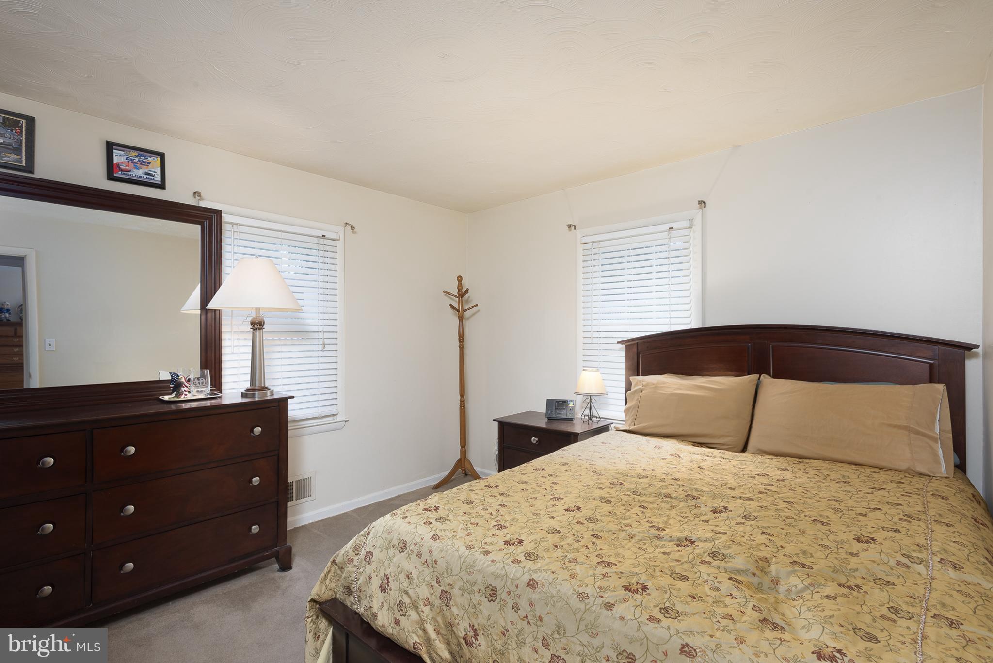 129 West Edgevale Road Baltimore, MD 21225 - Photo 14 of 18 a bedroom with a bed and a dresser