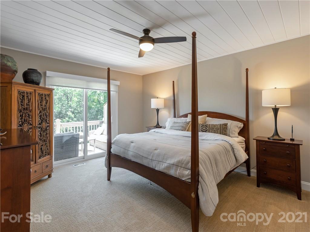 116 Country Ridge Road Laurel Park, NC 28739 - Photo 18 of 26 a bedroom with a large bed and a large window