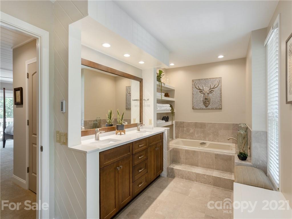 116 Country Ridge Road Laurel Park, NC 28739 - Photo 20 of 26 a bathroom with a tub sink and mirror