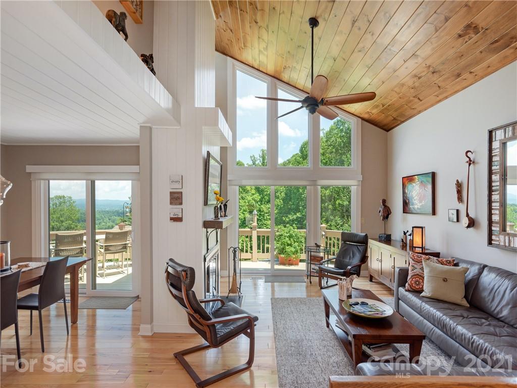 116 Country Ridge Road Laurel Park, NC 28739 - Photo 6 of 26 a living room with furniture a ceiling fan and a large window
