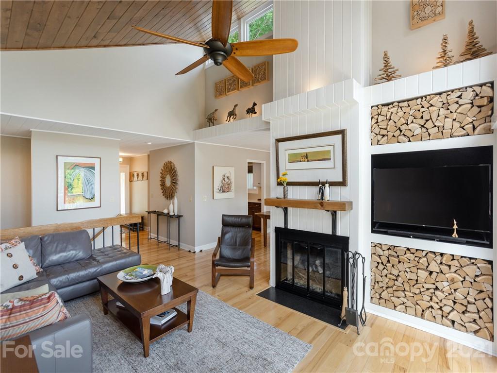 116 Country Ridge Road Laurel Park, NC 28739 - Photo 8 of 26 a living room with furniture a flat screen tv and a fireplace