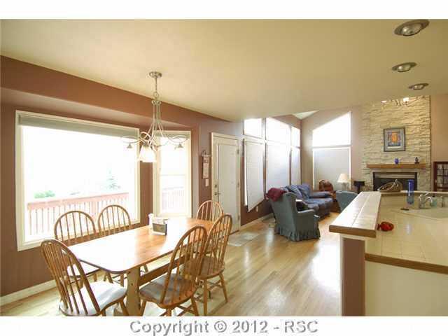 17710 New London Road Monument, CO 80132 - Photo 9 of 15 HArdwood floors and walkout to the 47 foot long back deck. Kitchen is to the right.