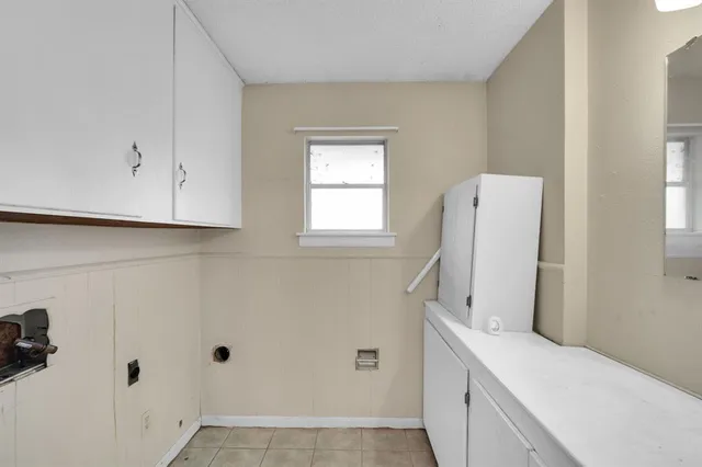 a bathroom with a double vanity sink window and mirror
