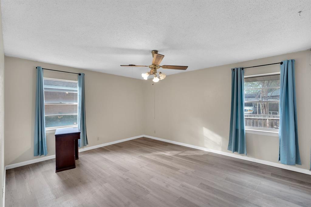 1320 Apache Street Arlington, TX 76012 - Photo 17 of 27 wooden floor in an empty room with a window