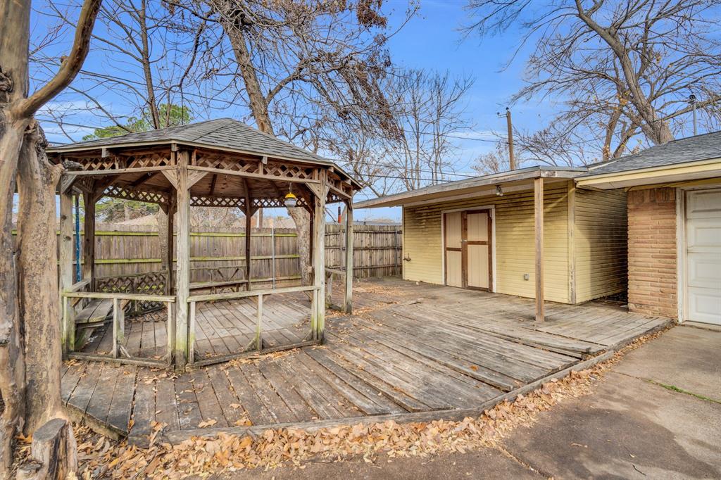 1320 Apache Street Arlington, TX 76012 - Photo 27 of 27 a view of a wooden house with a yard