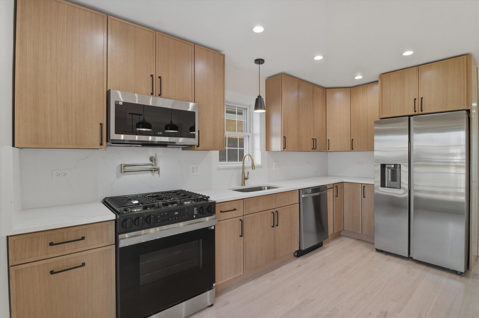 7230 South Avers Avenue Chicago, IL 60629 - Photo 12 of 44 a kitchen with stainless steel appliances granite countertop a refrigerator stove a sink and a microwave