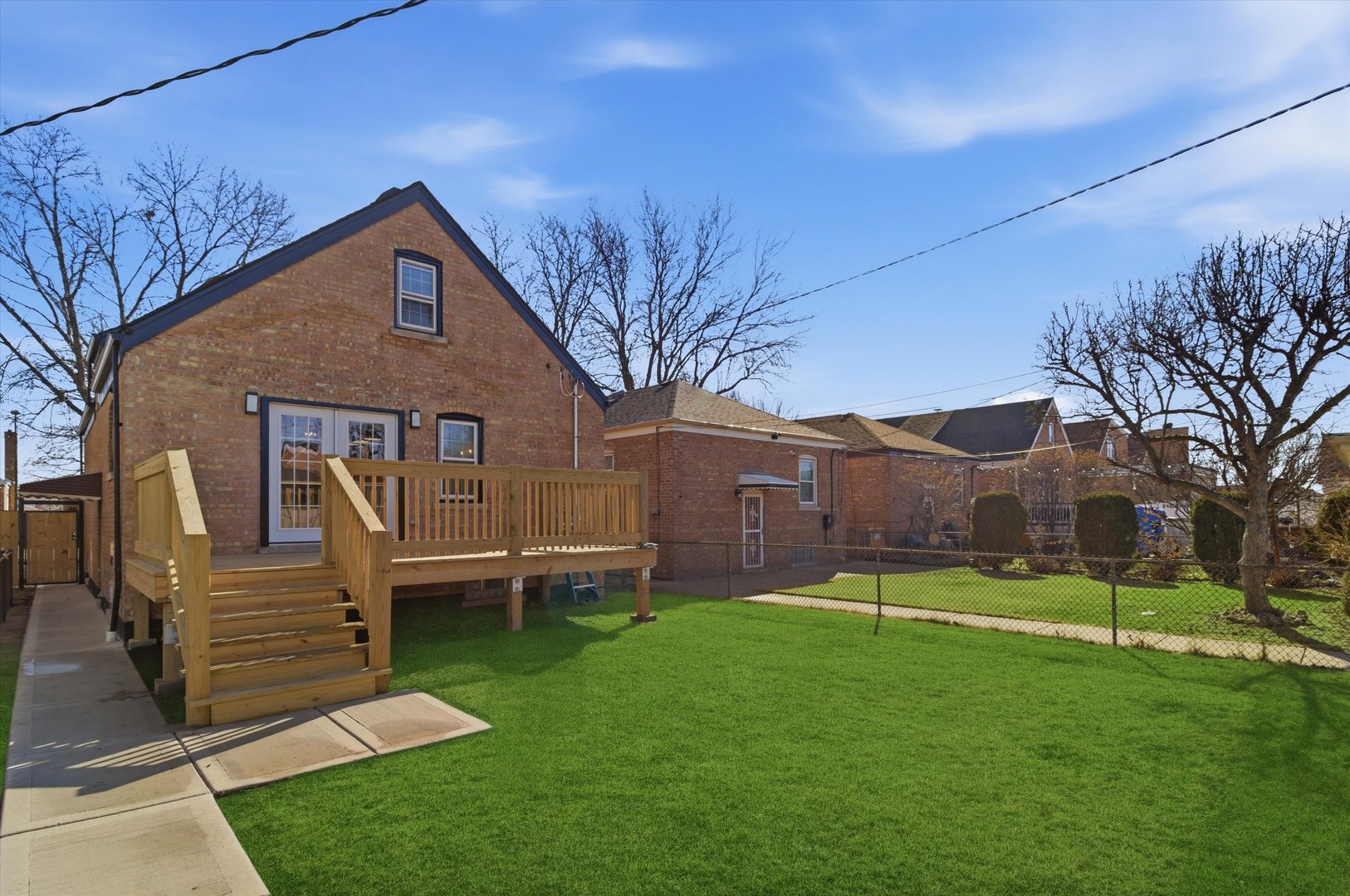 7230 South Avers Avenue Chicago, IL 60629 - Photo 35 of 44 a backyard of a house with wooden fence and large trees