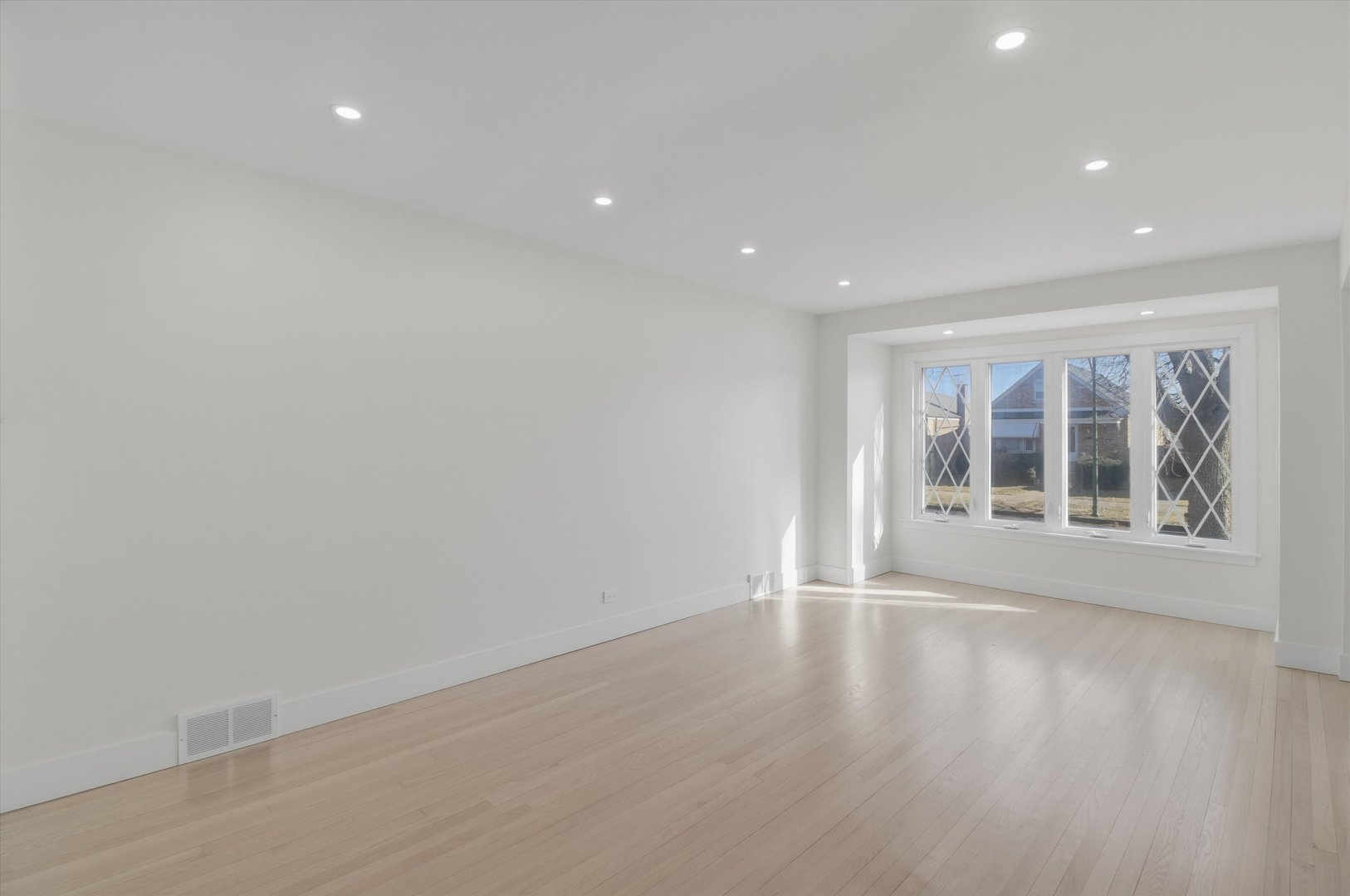 7230 South Avers Avenue Chicago, IL 60629 - Photo 4 of 44 a view of an empty room with wooden floor and a window
