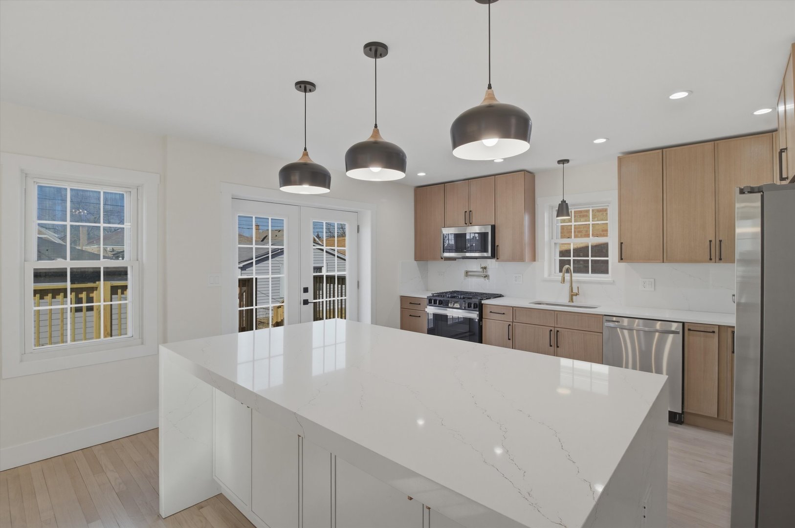 7230 South Avers Avenue Chicago, IL 60629 - Photo 7 of 44 a kitchen with stainless steel appliances granite countertop a stove a sink a center island and a window