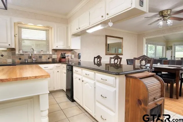 a kitchen with stainless steel appliances granite countertop a sink and cabinets
