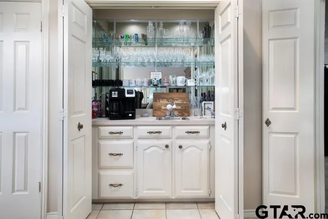 a kitchen with a refrigerator and cabinets