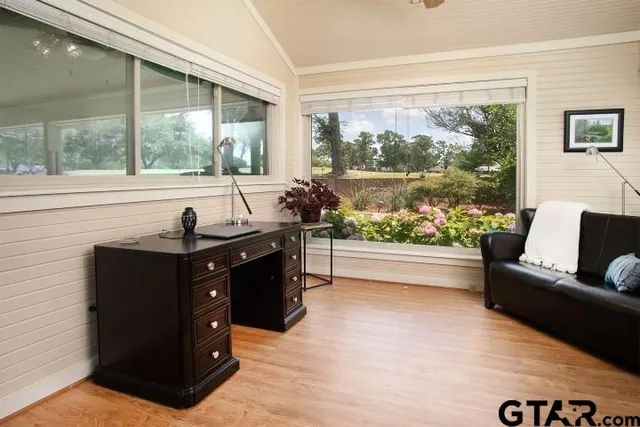 a living room with furniture and a large window