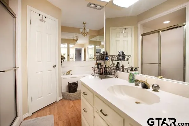 a bathroom with a sink double vanity and a shower