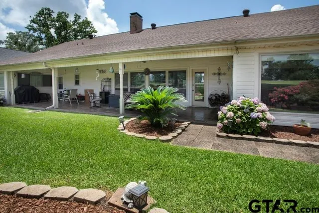 a front view of a house with porch and garden