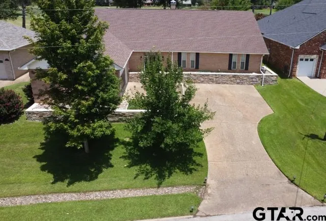 an aerial view of a house with a yard