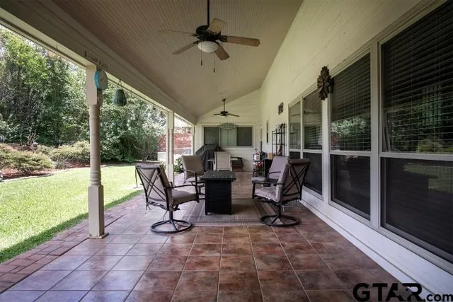 a view of a porch with chairs and backyard