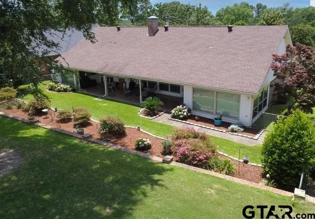 a aerial view of a house with a yard table and chairs