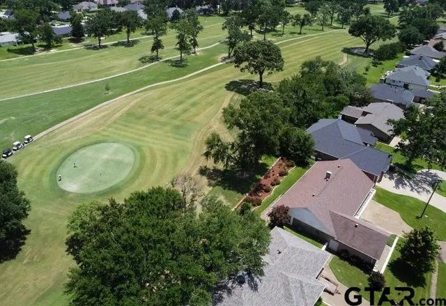 an aerial view of a house with a yard basket ball court and outdoor seating