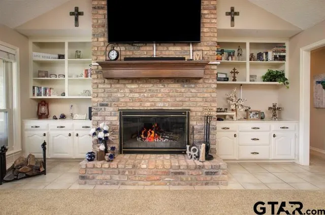 a living room with furniture and a fireplace