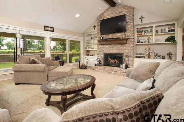a living room with furniture fireplace and a flat screen tv