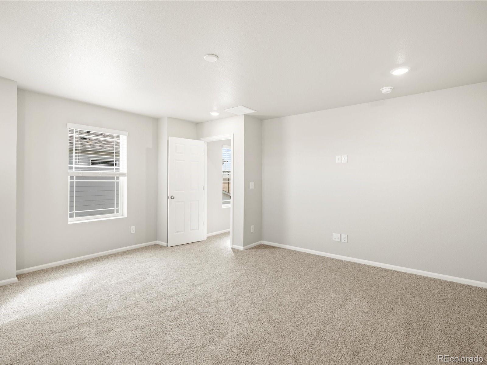 17517 East 89th Way Commerce City, CO 80022 - Photo 22 of 31 an empty room with windows