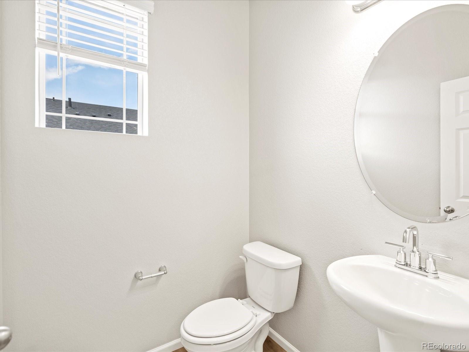 17517 East 89th Way Commerce City, CO 80022 - Photo 4 of 31 a white toilet sitting next to a bathroom sink