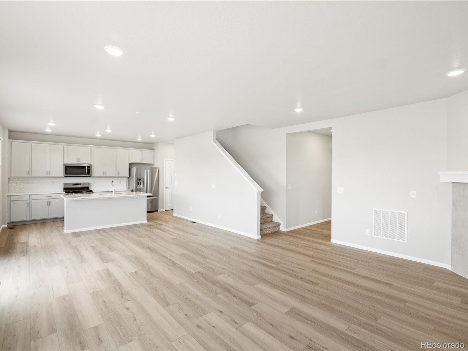 17517 East 89th Way Commerce City, CO 80022 - Photo 6 of 31 a view of kitchen with kitchen island and stainless steel appliances