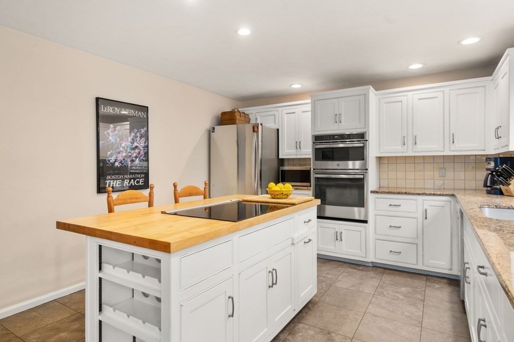 24 Parmenter Road Framingham, MA 01701 - Photo 19 of 42 a kitchen with white cabinets and white appliances