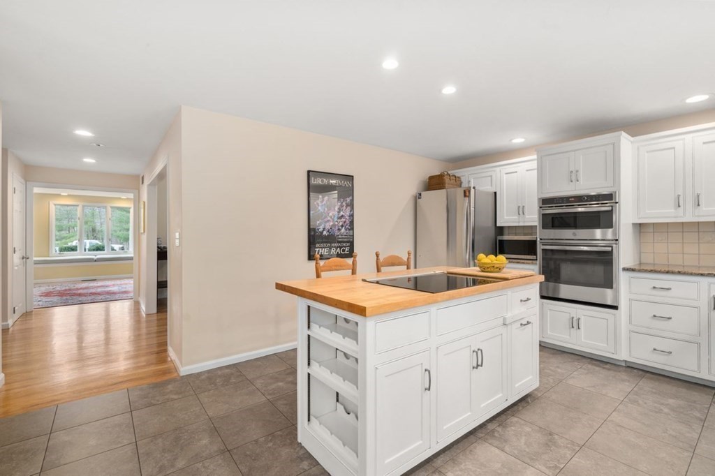 24 Parmenter Road Framingham, MA 01701 - Photo 20 of 42 a kitchen that has a lot of cabinets in it and wooden floors